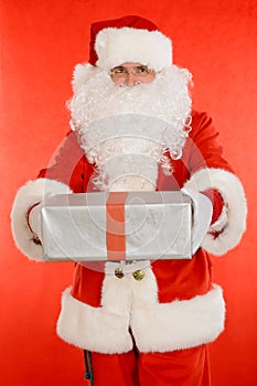 Santa Claus holding nicely wrapped present