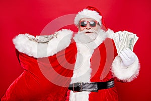 Portrait of Santa in eyeglasses gloves outfit holding carrying h