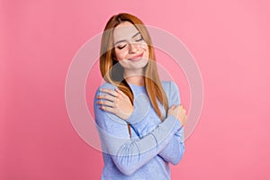 Portrait of satisfied adorable girl with foxy hairdo wear blue pullover hug herself enjoy fresh clothes isolated on pink
