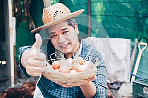 Portrait of satisfied excited hard-working delightful rejoicing handsome friendly kind farmer holding small basket