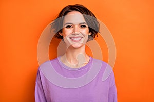 Portrait of satisfied glad young person toothy beaming smile look camera isolated on orange color background