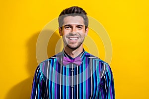 Portrait of satisfied optimistic positive guy dressed stylish shirt bow tie smile on camera isolated on bright yellow