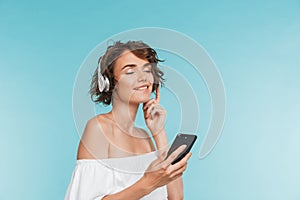 Portrait of a satisfied young woman listening to music