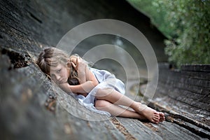 Portrait of scared little girl in forest