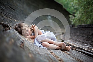 Portrait of scared little girl in forest