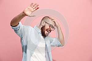 Portrait of the scared man on pink