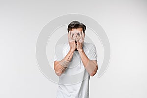 Portrait of the scared man on white