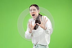 Portrait of the scared woman on green