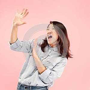 Portrait of the scared woman on pink