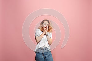 Portrait of the scared woman on pink