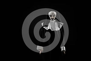 Portrait of scary devilish nun on black background, space for text. Halloween party look