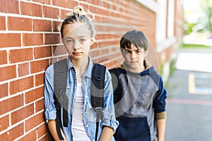 Portrait of school 10 years boy and girl having fun outside