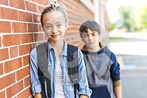 Portrait of school 10 years boy and girl having fun outside