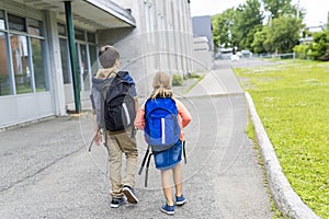 Portrait of school 10 years boy and girl walk outside