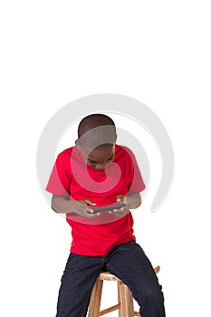 Portrait of a school aged boy with a cell phone