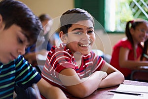 Portrait Of School Boy Looking At Camera In Class