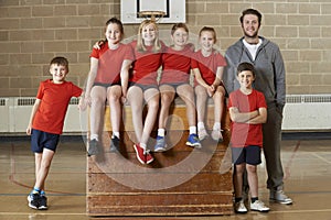 Portrait Of School Gym Team Sitting On Vaulting Horse