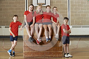 Portrait Of School Gym Team Sitting On Vaulting Horse