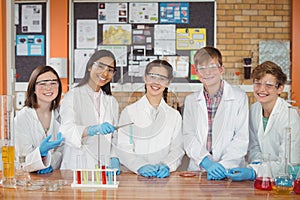 Portrait of school kids doing a chemical experiment in laboratory