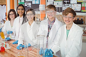 Portrait of school kids doing a chemical experiment in laboratory