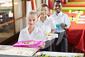 Portrait of school kids having lunch during break time