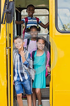 Portrait of school kids looking from bus