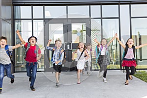 Portrait Of School Pupils Outside Classroom Carrying Bags