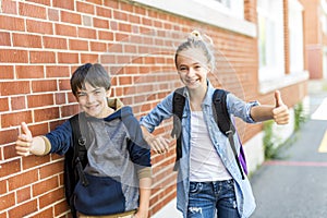 Portrait of school 10 years boy and girl having fun outside