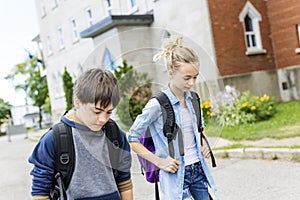 Portrait of school 10 years boy and girl having fun outside