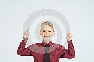 A portrait of a schoolboy showing thumbs up