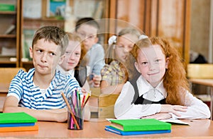 Portrait of schoolkids looking at camera at workplace