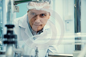 Portrait of a scientist, apothecary extracting cannabis oil in laboratory.