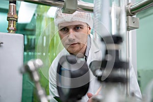 Portrait of a scientist, apothecary extracting cannabis oil in laboratory.