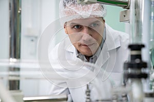 Portrait of a scientist, apothecary extracting cannabis oil in laboratory.