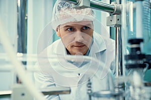 Portrait of a scientist, apothecary extracting cannabis oil in laboratory.