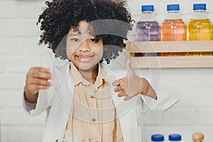 Portrait Scientist Kid in school with science lab kit. Learning education black child girl happy smiling thumbs up