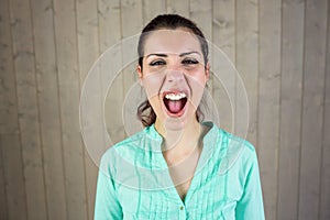 Portrait of screaming woman suffering from headache