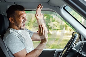 Portrait of a screaming young business man getting into car accident while driving