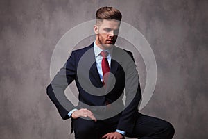 Portrait of seated businessman looking down to side