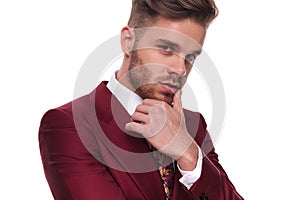 Portrait of seductive man in grena suit thinking