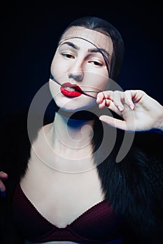 Portrait of a seductive young woman with red lipstick
