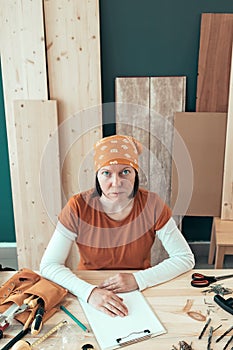 Portrait of self employed female carpenter in her woodwork workshop