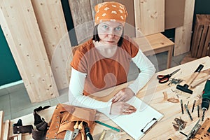 Portrait of self employed female carpenter in her woodwork workshop