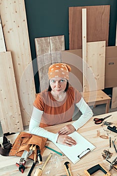 Portrait of self employed female carpenter in her woodwork workshop