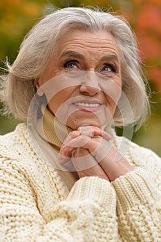 Portrait of senior beautiful woman in autumnal park