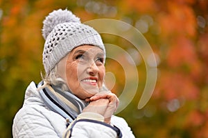 Portrait of senior beautiful woman in autumnal park