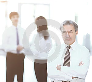 Portrait of a senior businessman on blurred background office