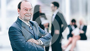 Portrait of a senior businessman on blurred background office