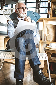 Portrait of senior businessman sitting at his office.