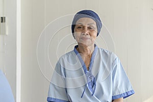 Portrait of senior cancer patient woman wearing head scarf in hospital, healthcare and medical concept